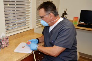 dentist working on dentures