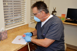 dentist working on dentures