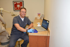 dentist using intraoral camera