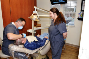 dentist and dental assistant working on patient